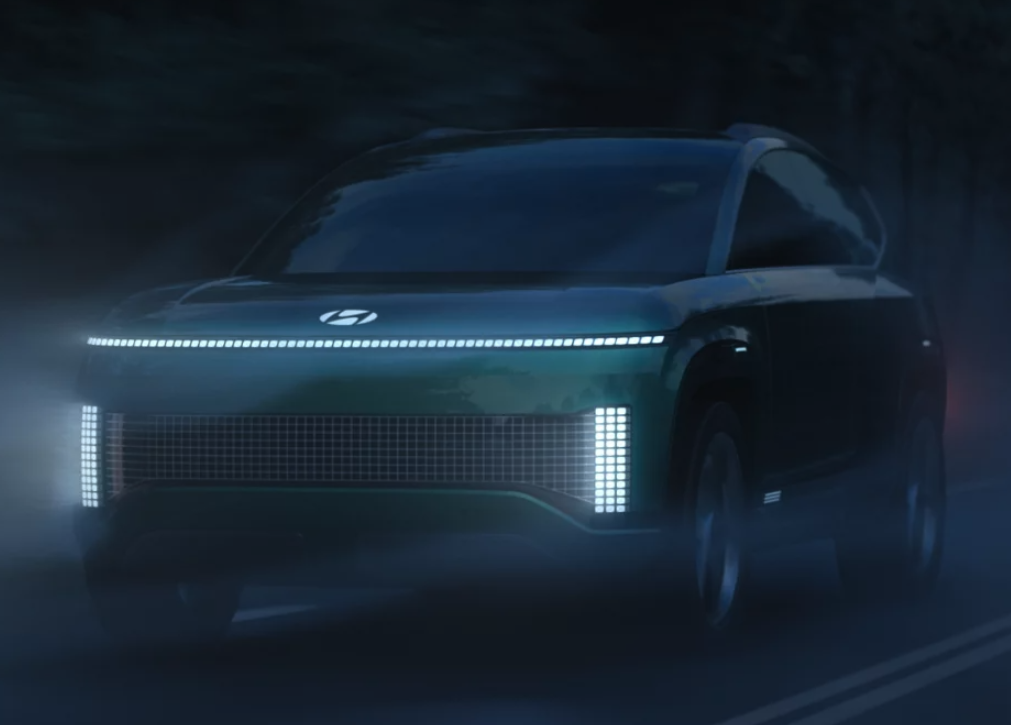 Hyundai Ioniq electric SUV concept illuminated on a foggy road at night
